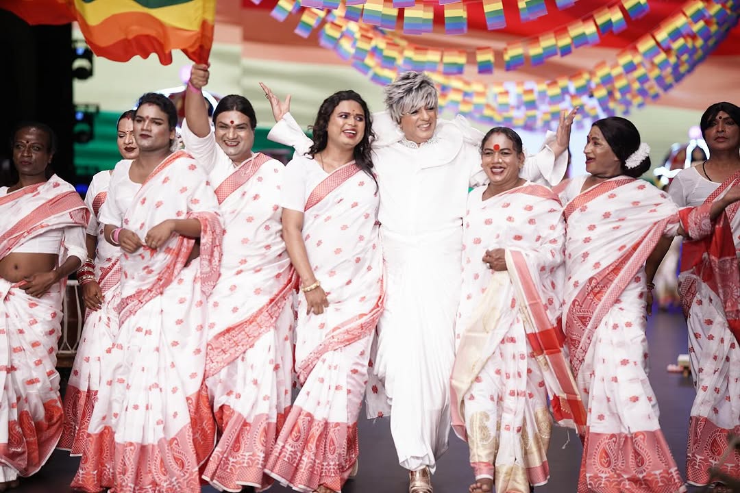 Diverse group of models in traditional Indian attire celebrating on runway during inclusive fashion show