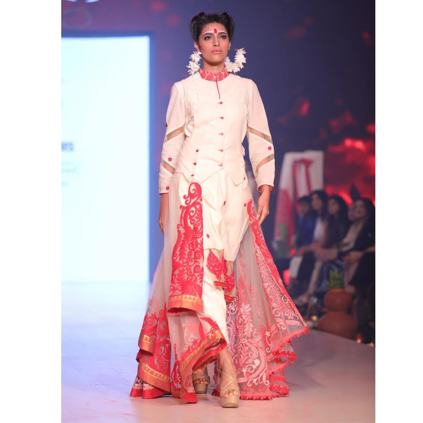 Behind-the-scenes moment in Rohit Verma's atelier showing diverse team members collaborating on fashion designs